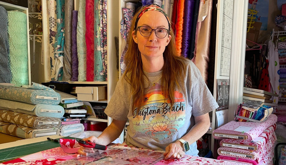 Person working on a sewing project in a fabric store